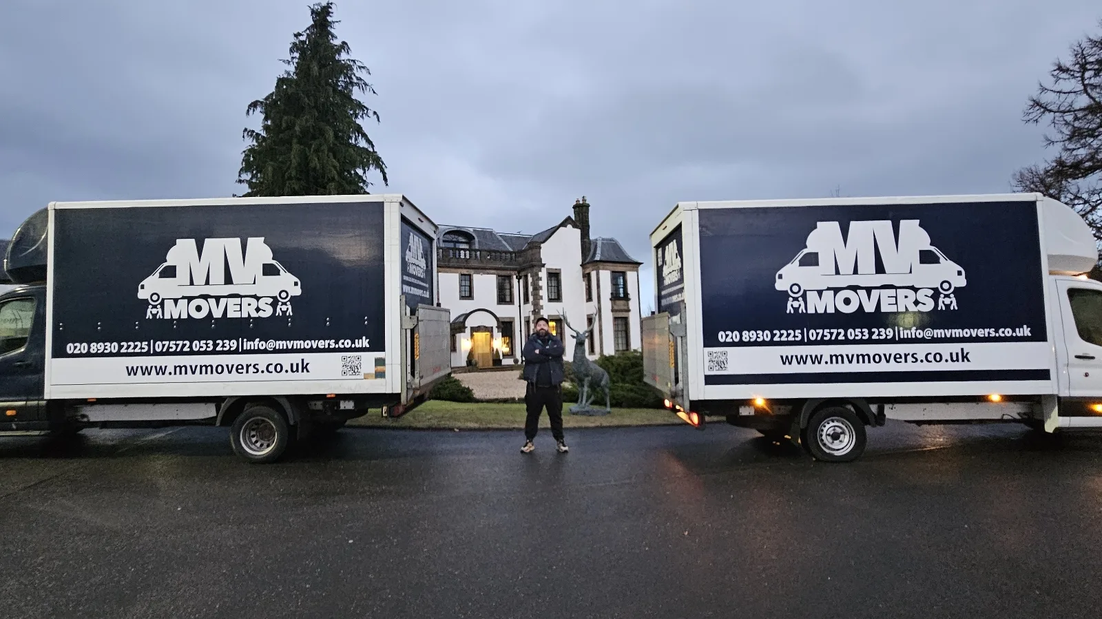 Two MV Movers Luton vans with the owner between them on a removals job, branded with the phone numbers and www.mvmovers.co.uk